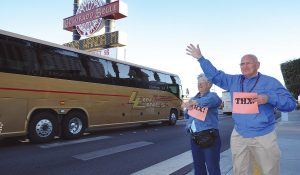 Clifford Boyer and Marge Sheldon hold signs of support during the motorcoach cruise.
