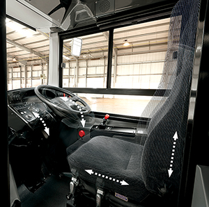The driving compartment with adjustable suspension seat, steering wheel and instrument binnacle.