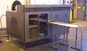 This mock-up of an engine compartment tests the performance of the suppression system under different driving conditions. Tests include both small and large fires under varying conditions of air flow, temperature and size of ventilation openings in the test rig. 